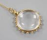 An early 20th century 15ct mounted eye glass pendant, 29mm, on a yellow metal fine link chain, gross 9.3 grams.                                                                                                             