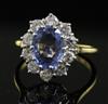 A modern 18ct gold, sapphire and diamond oval cluster ring, size O.                                                                    