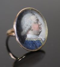 A George III gold and inset oval portrait miniature ring, painted with the bust of a gentleman to sinister,                            