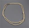 A twin strand graduated cultured pearl necklace with yellow metal and four stone diamond set clasp, 52cm                               