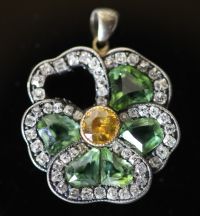 A late Victorian gold and silver, shaped chrysoberyl? and rose cut diamond set 'pansy' cluster pendant (stone missing),                