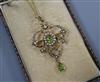 An Edwardian 9ct, peridot and seed pearl set drop pendant on a yellow metal chain, pendant 40mm.                                       