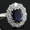 A modern white gold?, sapphire and diamond set oval cluster ring, size N.                                                              