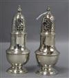 Two similar George II silver pepperettes/casters, Samuel Wood, London, 1742 & 1743, (af),                                              