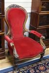 A Victorian carved walnut open armchair on turned legs                                                                                 