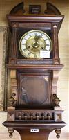 A late Victorian walnut eight day wall clock                                                                                           