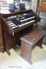 A Hammond organ, XT-100/XH-200 with stool and a quantity of music books. W-125.                                                                                                                                             