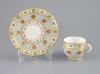 A Royal Worcester 'jewelled' and reticulated cup and saucer                                                                                                                                                                 