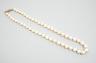 A single strand graduated pearl necklace (not tested for natural), with yellow metal and three stone diamond set clasp, 44cm.                                                                                               