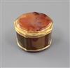 A late 18th/early 19th century Swiss? gold mounted banded agate shaped circular pill box, 43mm.                                        