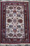 A Persian cream ground rug with central field of foliate motifs                                                                        