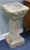 A pair of stone planters on columns W.40cm approx                                                                                      