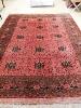 An Afghan red ground carpet, 360 x 260cm                                                                                                                                                                                    