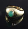 An 18ct gold and cabochon jade ring, size V.                                                                                           