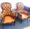 A pair of Victorian walnut and tan leather spoonback armchairs                                                                                                                                                              