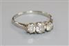 An 18ct white gold and platinum three stone diamond ring, size P.                                                                      