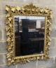 A late 19th century Florentine carved giltwood wall mirror with vineous frame width 97 cm Height 116 cm.                                                                                                                    