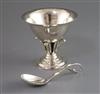 A Georg Jensen planished silver sugar bowl with everted rim on pierced foliate pedestal and circular foot and a matching spoon,        