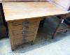 A 1940's oak kneehole desk, stamped G.R. W-107, D-59, H-73cm.                                                                                                                                                               