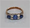 An early 20th century 18ct gold, three stone sapphire and four stone diamond ring, size M.                                             