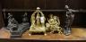 Three gilt metal deities, a faux bronze figure and one other, largest height 37cm                                                                                                                                           