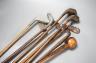 Golf clubs, knobkerrie in a leather carrier, carrier 50cms high.                                                                                                                                                            