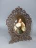 A large 19th century painted Paris porcelain plaque of a girl in a Black Forest carved frame, height 44cm overall                                                                                                           