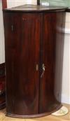 A George III mahogany bow front hanging corner cupboard W.65cm                                                                         