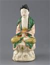 A Chinese Sancai glazed pottery seated figure of Guanyin, Qing dynasty, H.27cm, some flaking to glaze                                  