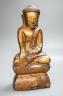 A Burmese gilded carved wooden figure of Buddha, 35 cms high.                                                                                                                                                               