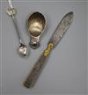 A silver shell caddy spoon, a Ceylonese white metal spoon and a 19th century steel and ormolu letter opener                            