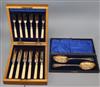 A cased set of six pairs of plated dessert eaters and a cased pair of plated berry spoons.                                             