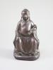 A Chinese Zitan seated figure of an official, 18th century, 19.3cm high                                                                                                                                                     