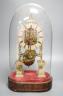 A Victorian brass skeleton clock, with single fusee movement, under a glass dome 43 cms high.                                                                                                                               