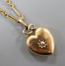 An Edwardian yellow metal and seed pearl set heart shaped locket, with glazed panel back, overall 29mm, on a yellow metal ovoid and spherical link chain, 61cm and a 9c fine link chain (a.f.)                              