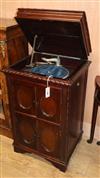 A 1930's gramophone, contained in a carved mahogany cabinet (top split)                                                                