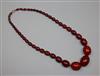 A single strand graduated simulated cherry amber bead necklace, gross weight 75 grams, 62cm.                                           