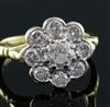 A modern 18ct gold and nine stone diamond flowerhead cluster ring, size J.                                                             