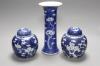 Two Chinese blue and white prunus pattern ginger jars and a similar cylinder vase, tallest 26cm                                                                                                                             