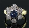 A modern 18ct gold, sapphire and diamond seven stone flowerhead cluster ring, size J/K.                                                