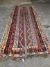 A Kilim polychrome flatweave carpet, cut centrally to create a pair of runners, each 440 x 97cm                                                                                                                             