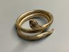 A 1960’s nine carat gold coiled serpent bracelet with ruby eyes, gross weight 30 .1 g.                                                                                                                                      