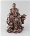 A Japanese wood okimono of the Empress-Consort Jingu seated on a rock, Meiji period, total height 35.5cm                               