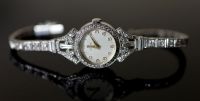 A lady's early 1960's 18ct gold, palladium and diamond set Omega manual wind cocktail watch, on diamond set bracelet,                  