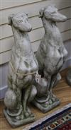 A pair of reconstituted stone model of hounds sejant H.74cm                                                                            