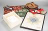 A group of WWI and WWII militaria badges, buttons, two swagger sticks, a Third Reich armband and a World War I German POW inscribed plaster ornament, longest swagger stick 70 cms long.                                    