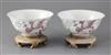 A pair of Chinese famille rose 'phoenix' bowls, Guangxu period, 15.4cm diameter, wood stands                                           