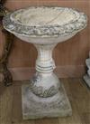 A reconstituted garden bird bath, raised on a square plinth W.61cm                                                                     