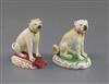 Two Rockingham porcelain figures of seated pug dogs, c.1830, H.7cm, latter restored                                                    