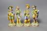 A set of four 19th century faience figures of street peddlers or performers - 18cm tall                                                                                                                                     